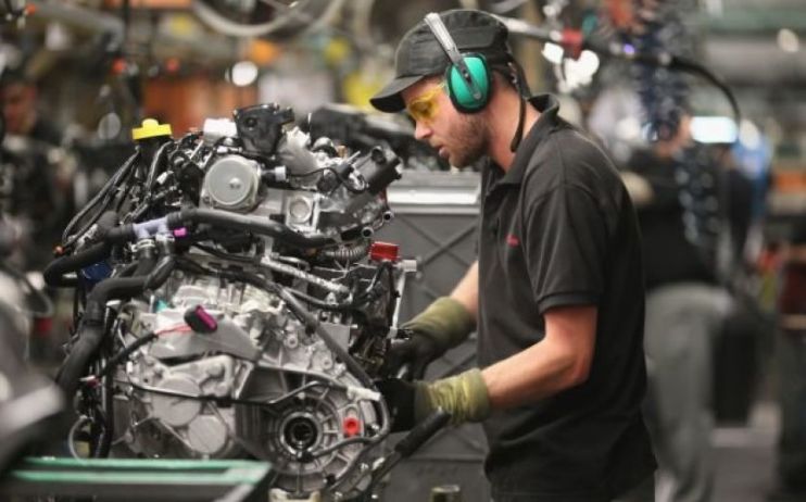 A factory worker examines an engine as the Eurozone's auto sector was particularly badly affected by macroeconomic factors