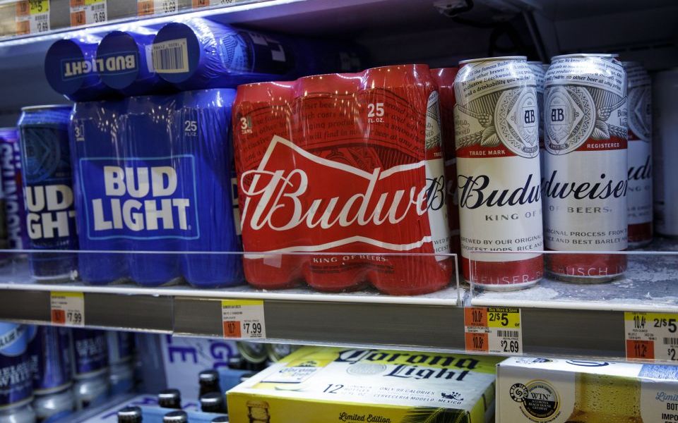Budweiser maker AB inBev backed its full year guidance despite reporting a fall in volumes due to weak demand in the US and soft industry in Europe in the third quarter. 