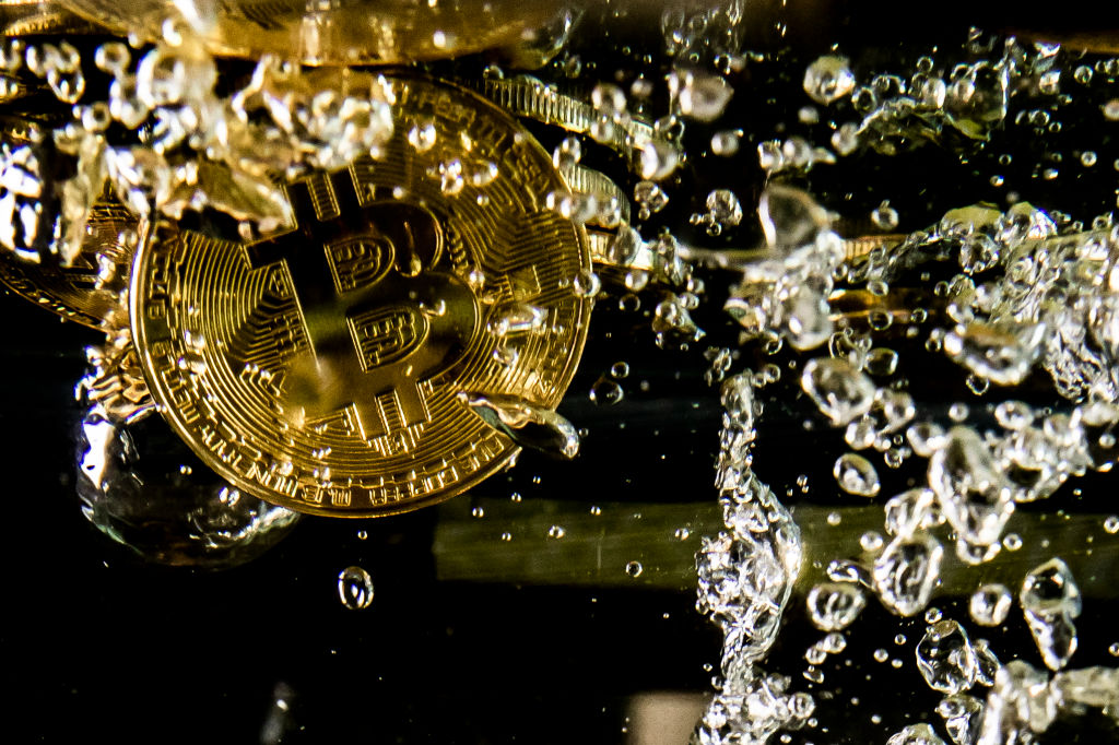 LONDON, ENGLAND - AUGUST 15: In this photo illustration a visual representation of the digital currency Bitcoin sinks into water on August 15, 2018 in London, England. Most digital currencies including Bitcoin, (BTC) Ethereum, (ETH) Ripple (XRP) and Stella (XLM) have seen a dramatic fall in their prices throughout 2018 amid a 'mass sell-off'. In December 2017 the price of BTC hit $20,000 USD but has since fallen to around $6000 USD.   (Photo Illustration by Dan Kitwood/Getty Images)