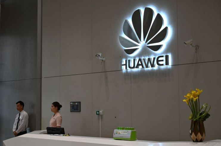 In this picture taken on May 29, 2019, a company logo is displayed at a reception area at the Huawei headquarters in Shenzhen, China's Guangdong province. - Huawei's main Shenzhen campus is a sprawling, lavishly landscaped mix of glass office towers, labs and training centres, including a white-columned neo-classical research site the size of a city block and cheekily dubbed the "White House" for its resemblance to US President Donald Trump's current address. (Photo by HECTOR RETAMAL / AFP) / To go with China-US-trade-Huawei-telecommunication, SCENE by Dan Martin (Photo credit should read HECTOR RETAMAL/AFP/Getty Images)