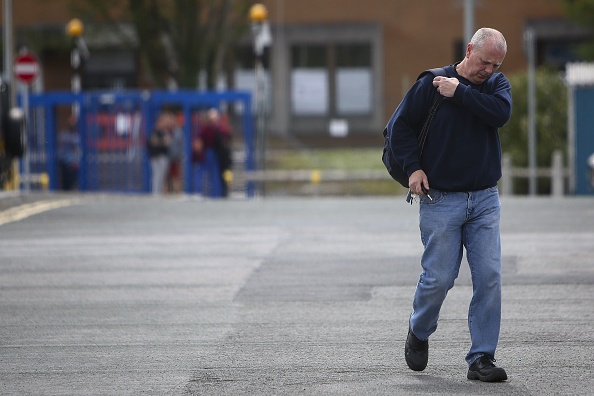 A Ford worker is pictured leaving the Bridgend plant last night, after hearing of its potential closure