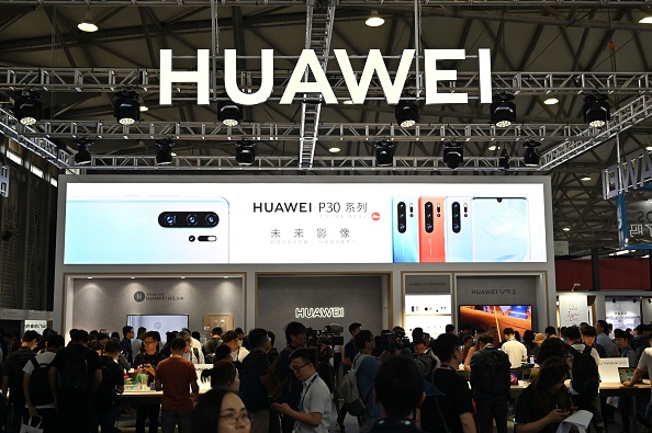People gather at a Huawei stand during the Consumer Electronics Show, Ces Asia 2019 in Shanghai on June 11, 2019. (Photo by HECTOR RETAMAL / AFP) (Photo credit should read HECTOR RETAMAL/AFP/Getty Images)