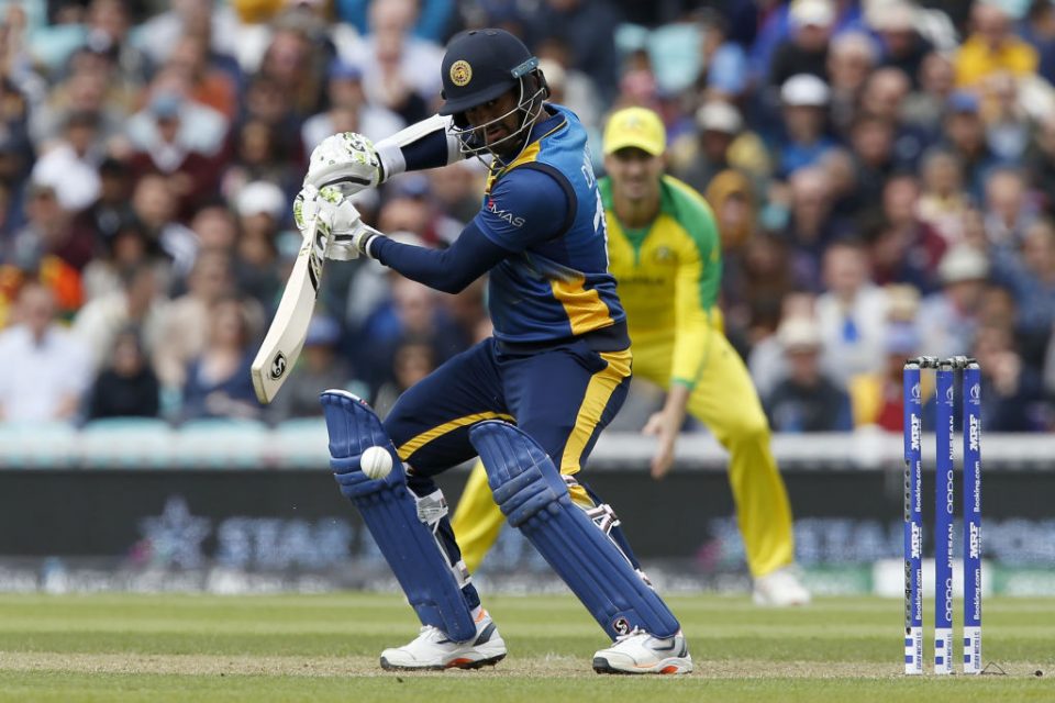 Sri Lanka's captain Dimuth Karunaratne plays a shot during the 2019 Cricket World Cup group stage match between Sri Lanka and Australia at The Oval in London on June 15, 2019. (Photo by Ian KINGTON / AFP) / RESTRICTED TO EDITORIAL USE        (Photo credit should read IAN KINGTON/AFP/Getty Images)