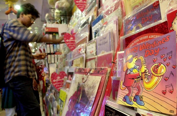 DHAKA, BANGLADESH:  A young Bangladeshi man chooses a Valentine's Day card from a selection on display in a gift shop in Dhaka, 12 February 2005.   A large number of Bangladeshi youths are preparing to celebrate Valentines Day on 14 February 2005, despite the opposition by Islamic religious leaders saying that the western practice of sending cards and roses to one's lover contravenes Islamic ideology.   AFP PHOTO/Farjana K. GODHULY  (Photo credit should read FARJANA K. GODHULY/AFP/Getty Images)