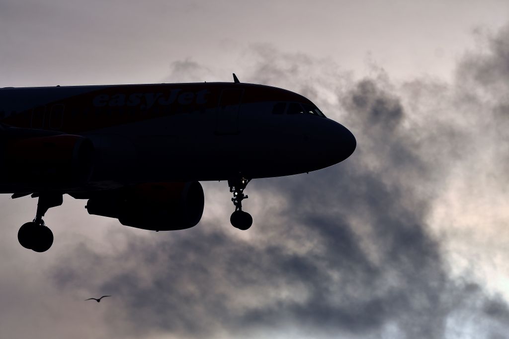 TOPSHOT - An EasyJet aircraft prepares to land at London Gatwick Airport, south of London, on December 21, 2018, as flights resumed following the closing of the airfield due to a drones flying. - British police were Friday considering shooting down the drone that has grounded flights and caused chaos at London's Gatwick Airport, with passengers set to face a third day of disruption. Police said it was a "tactical option" after more than 50 sightings of the device near the airfield since Wednesday night when the runway was first closed. (Photo by Ben STANSALL / AFP)        (Photo credit should read BEN STANSALL/AFP/Getty Images)