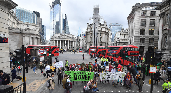 LONDON, ENGLAND - APRIL 25: Envrionmental campaigners from the "Extinction Rebellion" group block the junction at Bank as part of their ongoing actions and protests across the capital on April 25, 2019 in London, England. Organisers have said demonstrators will target the financial industry as it is due to end blockades at Parliament Square and Marble Arch on the eleventh and final day. The protests have involved roadblocks, sit-ins and the halting of sections of the public transport system, in a bid to highlight environmental concerns. (Photo by Leon Neal/Getty Images)