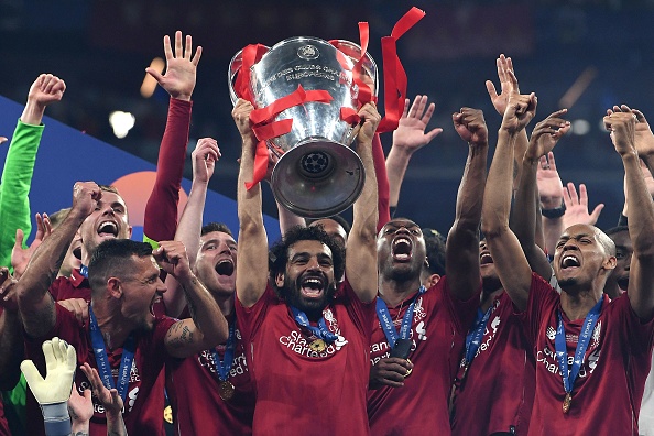 TOPSHOT - Liverpool's Egyptian forward Mohamed Salah (C) raises the European Champion Clubs' Cup as he celebrates with teammates winning the UEFA Champions League final football match between Liverpool and Tottenham Hotspur at the Wanda Metropolitano Stadium in Madrid on June 1, 2019. (Photo by Paul ELLIS / AFP)        (Photo credit should read PAUL ELLIS/AFP/Getty Images)