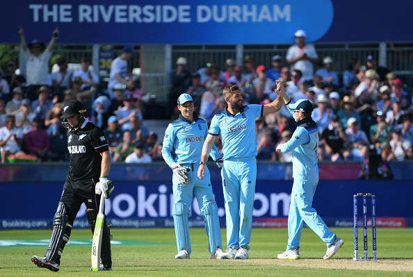 England's Liam Plunkett (2R) celebrates with teammate Jos Buttler (2L) and captain Eoin Morgan (R) after the dismissal of New Zealand's Tom Latham (L) during the 2019 Cricket World Cup group stage match between England and New Zealand at the Riverside Ground, in Chester-le-Street, northeast England, on July 3, 2019. (Photo by Paul ELLIS / AFP) / RESTRICTED TO EDITORIAL USE (Photo credit should read PAUL ELLIS/AFP/Getty Images)