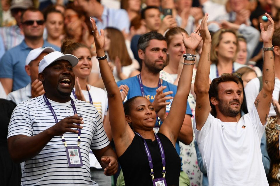 The team of US player Cori Gauff, including her father Corey (L), mother Candi (C) and French tennis coach Jean-Christophe Faurel (R) celebrate after Gauff beat Slovenia's Polona Hercog during their women's singles third round match on the fifth day of the 2019 Wimbledon Championships at The All England Lawn Tennis Club in Wimbledon, southwest London, on July 5, 2019. (Photo by Daniel LEAL-OLIVAS / AFP) / RESTRICTED TO EDITORIAL USE        (Photo credit should read DANIEL LEAL-OLIVAS/AFP/Getty Images)