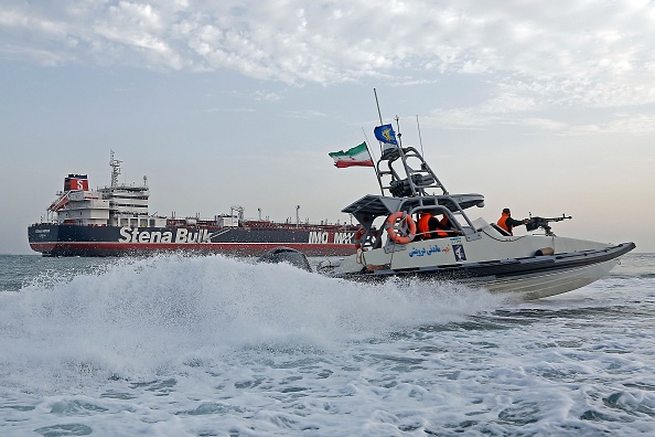 A picture taken on July 21, 2019, shows Iranian Revolutionary Guards patrolling around the British-flagged tanker Stena Impero as it's anchored off the Iranian port city of Bandar Abbas. - Iran warned Sunday that the fate of a UK-flagged tanker it seized in the Gulf depends on an investigation, as Britain said it was considering options in response to the standoff. Authorities impounded the Stena Impero with 23 crew members aboard off the port of Bandar Abbas after the Islamic Revolutionary Guard Corps seized it Friday in the highly sensitive Strait of Hormuz. (Photo by Hasan Shirvani / MIZAN NEWS AGENCY / AFP) (Photo credit should read HASAN SHIRVANI/AFP/Getty Images)