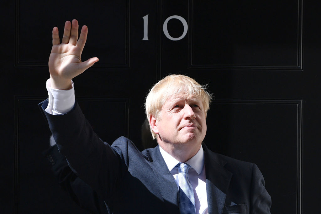 LONDON, ENGLAND - JULY 24: New Prime Minister Boris Johnson waves from the door of Number 10, Downing Street after speaking to the media on July 24, 2019 in London, England.  Boris Johnson, MP for Uxbridge and South Ruislip, was elected leader of the Conservative and Unionist Party yesterday receiving 66 percent of the votes cast by the Party members. He takes the office of Prime Minister this afternoon after outgoing Prime Minister Theresa May took questions in the House of Commons for the last time. (Photo by Jeff J Mitchell/Getty Images)