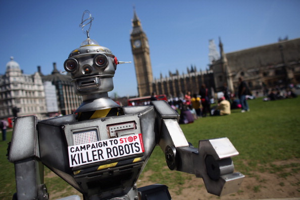 LONDON, ENGLAND - APRIL 23:  A robot distributes promotional literature calling for a ban on fully autonomous weapons in Parliament Square on April 23, 2013 in London, England. The 'Campaign to Stop Killer Robots' is calling for a pre-emptive ban on lethal robot weapons that could attack targets without human intervention.  (Photo by Oli Scarff/Getty Images)