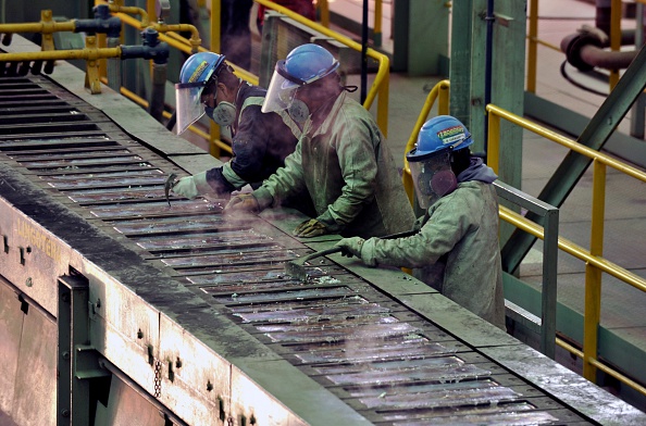 Workers check silver ingots at the Karachipampa silver and lead foundry in Potosi, south Bolivia 