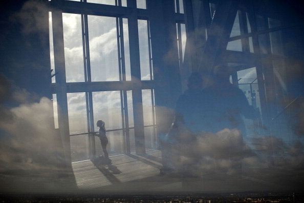LONDON, ENGLAND - JANUARY 27: A reflection of a girl looks out over London from The View at The Shard on January 27, 2014 in London, England. A study has found that one in three 22-30 year olds are leaving their hometowns to move to the capital, which creates ten times as many private sector jobs as any other city.  (Photo by Matthew Lloyd/Getty Images)