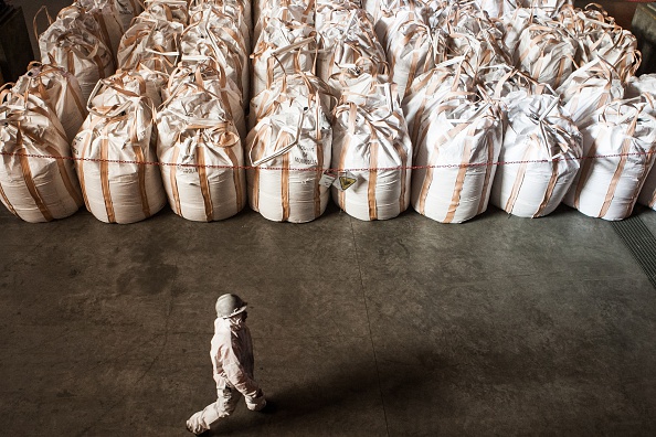 This photo taken on November 30, 2015 shows a worker walking past bags of copper concentrates in the factory of the Oyu Tolgoi mine in Khanbogd sum in Ömnögovi province in southern Mongolia. Anglo-Australian mining giant Rio Tinto secured a multi-billion deal on December 15 to finance its giant but controversial Oyu Tolgoi mine in Mongolia, which has been at the centre of rising resource nationalism in the sparsely populated Asian country.  AFP PHOTO/ BYAMBASUREN BYAMBA-OCHIR / AFP / Byambasuren Byamba-Ochir        (Photo credit should read BYAMBASUREN BYAMBA-OCHIR/AFP/Getty Images)