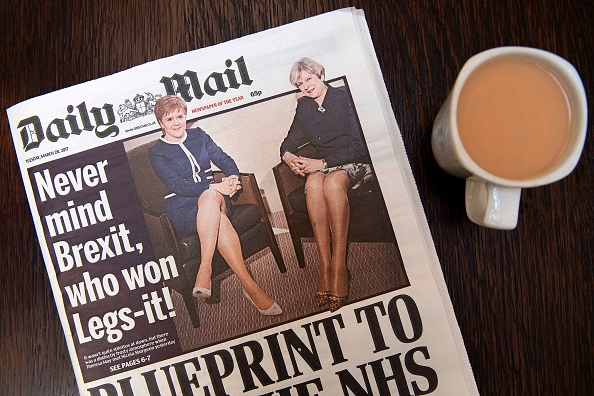 An arranged photograph shows a copy of today's Daily Mail newspaper, pictured in a coffee shop in central London on March 28, 2017, featuring on its front page a picture of Britain's Prime Minister Theresa May and Scotland's First Minister Nicola Sturgeon. Britain's Daily Mail newspaper faced a backlash Tuesday for comparing the legs on show when British Prime Minister Theresa May and Scottish First Minister Nicola Sturgeon held talks. While the two leaders clashed over Brexit, which May is set to trigger Wednesday, and Sturgeon's push for another Scottish independence referendum, the Mail spun it as a battle of the legs and focused on what could be read into their outfits and body language. / AFP PHOTO / Justin TALLIS (Photo credit should read JUSTIN TALLIS/AFP/Getty Images)