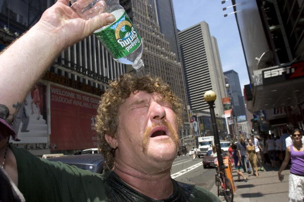 NEW YORK - JULY 18:  Wayne Semancik of Trenton, New Jersey pours water on his head to cool himself off July 18, 2006 in New York City. Temperatures are expected to stay above normal for the next several days.  (Photo by Michael Brown/Getty Images)