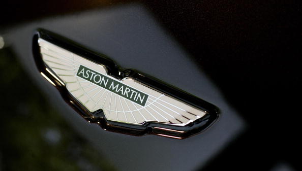 LONDON, United Kingdom:  An Aston Martin badge is photographed on a vehicle in a showroom in London, 01 September 2006.  US auto giant Ford announced Thursday it wants to hive off Aston Martin, the dashing sports car immortalized by fictional superspy James Bond. The loss-making Detroit company said it wanted to free up resources for its other auto brands, and said that prospective buyers had already come forward for the legendary British marque. AFP PHOTO / SHAUN CURRY  (Photo credit should read SHAUN CURRY/AFP/Getty Images)