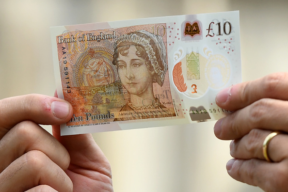WINCHESTER, UNITED KINGDOM - JULY 18:  Bank of England Governor Mark Carney poses with one of the central bank's new ten pound notes, featuring British author Jane Austen, during its unveiling at Winchester Cathedral on July 18, 2017 in Winchester, England. Two hundred years after Jane Austen's death, Britain is celebrating one of its best-loved authors, who combined romance with biting social commentary that still speaks to fans around the world. Austen is buried in the cathedral in Winchester, where she died.  (Photo by Chris J Ratcliffe-Pool/Getty Images)