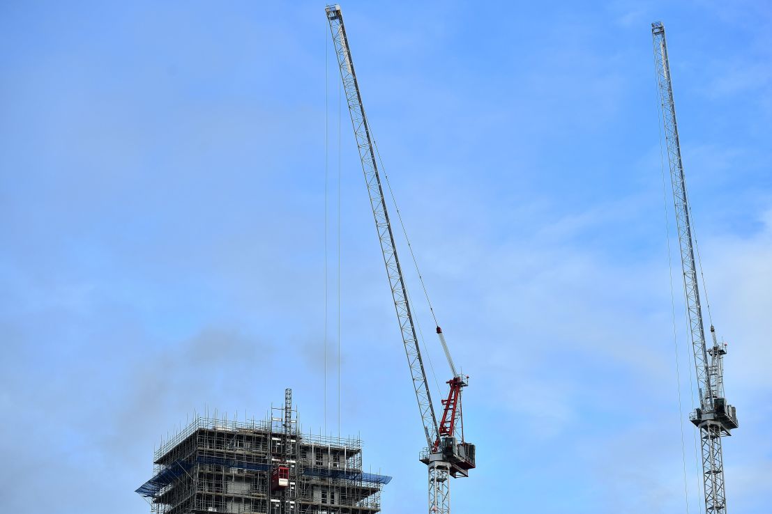 Construction cranes are pictured standing over a partially complete residential apartment complex in the Kidbrooke district of south-east London on October 26, 2018. - Chancellor of the Exchequer Philip Hammond will unveil the 2018 budget on October 29, 2018. (Photo by Ben STANSALL / AFP)        (Photo credit should read BEN STANSALL/AFP/Getty Images)