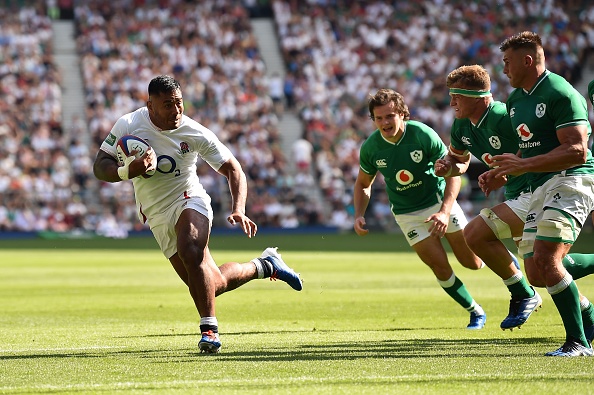 England's centre Manu Tuilagi (L) on his way to scoring a try during the international Test rugby union match between England and Ireland at Twickenham Stadium in west London on August 24, 2019. (Photo by Glyn KIRK / AFP)        (Photo credit should read GLYN KIRK/AFP/Getty Images)