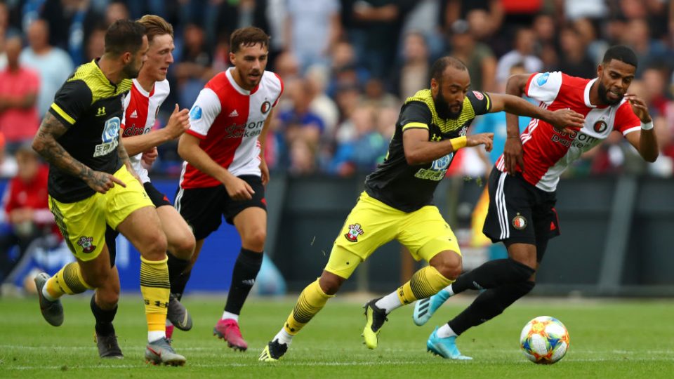 ROTTERDAM, NETHERLANDS - JULY 28: Nathan Redmond of Southampton battles for the ball with Jerry St. Juste of Feyenoord during the pre season friendly match between Feyenoord Rotterdam and Southampton Football Club at Stadion Feijenoord or De Kuip on July 28, 2019 in Rotterdam, Netherlands. (Photo by Dean Mouhtaropoulos/Getty Images)