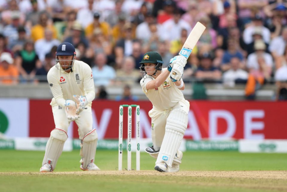 BIRMINGHAM, ENGLAND - AUGUST 04: Australia batsman Steven Smith hits out watched by Jonny Bairstow during day four of the First Specsavers Test Match between England and Australia at Edgbaston on August 04, 2019 in Birmingham, England. (Photo by Stu Forster/Getty Images)