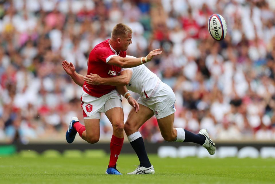 LONDON, ENGLAND - AUGUST 11:  Gareth Anscombe of Wales offloads under pressure from Willi Heinz of England during the 2019 Quilter International match between England and Wales at Twickenham Stadium on August 11, 2019 in London, England. (Photo by Dan Mullan/Getty Images)