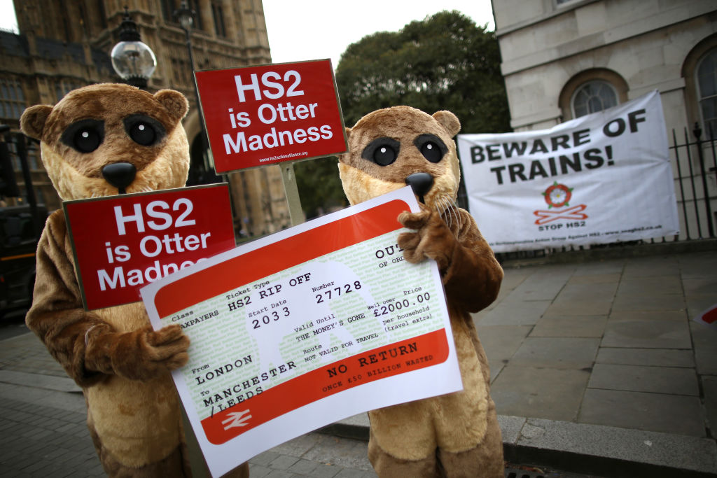 LONDON, ENGLAND - NOVEMBER 25:  Protestors dressed as otters demonstrating against the High Speed 2 (HS2) rail line gather near Parliament on November 25, 2013 in London, England. Legislation for the proposed HS2 line between London and Birmingham will be presented to Parliament today, in an attempt to gain support from MPs. (Photo by Peter Macdiarmid/Getty Images)