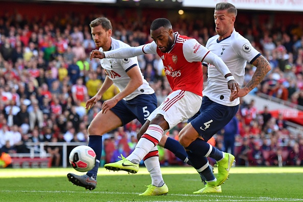 Arsenal's French striker Alexandre Lacazette shoots to score their first goal during the English Premier League football match between Arsenal and Tottenham Hotspur at the Emirates Stadium in London on September 1, 2019. (Photo by Ben STANSALL / AFP) / RESTRICTED TO EDITORIAL USE. No use with unauthorized audio, video, data, fixture lists, club/league logos or 'live' services. Online in-match use limited to 120 images. An additional 40 images may be used in extra time. No video emulation. Social media in-match use limited to 120 images. An additional 40 images may be used in extra time. No use in betting publications, games or single club/league/player publications. /         (Photo credit should read BEN STANSALL/AFP/Getty Images)