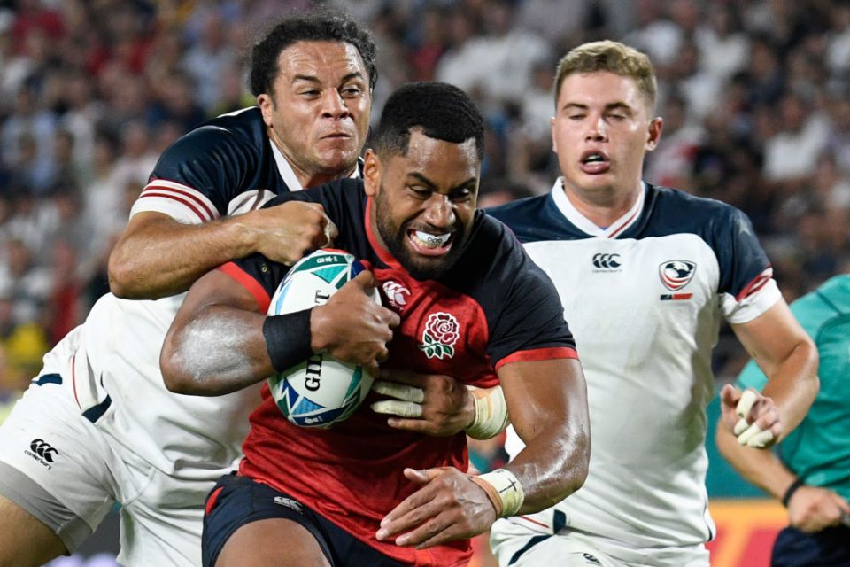 England's wing Joe Cokanasiga (C) is tackled by US prop David Ainuu (L) as he runs to score a try during the Japan 2019 Rugby World Cup Pool C match between England and the United States at the Kobe Misaki Stadium in Kobe on September 26, 2019. (Photo by Filippo MONTEFORTE / AFP) (Photo credit should read FILIPPO MONTEFORTE/AFP/Getty Images)