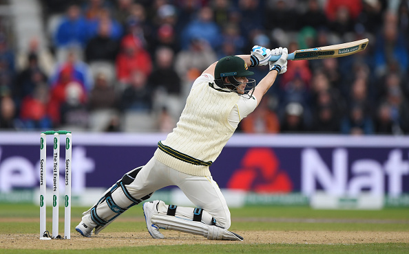 MANCHESTER, ENGLAND - SEPTEMBER 04: Australia batsman Steve Smith drives to the boundary for 4 runs to reach his half century during day one of the 4th Ashes Test match between England and Australia at Old Trafford on September 04, 2019 in Manchester, England. (Photo by Stu Forster/Getty Images)