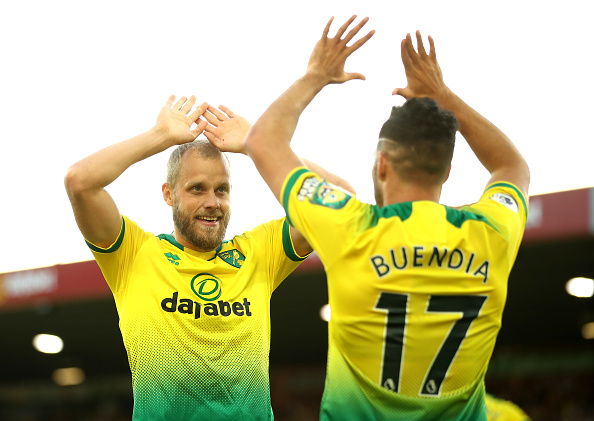 NORWICH, ENGLAND - SEPTEMBER 14: Teemu Pukki of Norwich City celebrates with teammate Emiliano Buendia of Norwich City after scoring his team's third goal during the Premier League match between Norwich City and Manchester City at Carrow Road on September 14, 2019 in Norwich, United Kingdom. (Photo by Marc Atkins/Getty Images)