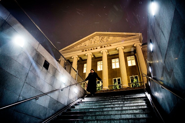 TOPSHOT - Picture taken on December 10, 2012 shows a woman stepping down stairs in front of the Danske Bank building in Copenhagen, Denmark. - Azerbaijan's ruling elite ran a secret 2.5 billion euro ($2.9 billion) slush fund to pay off European politicians and launder money, according to an investigation by a group of European newspapers published on September 5, 2017. One of Europe's leading banks, Denmark's Danske Bank, processed the payments via its Estonia office. (Photo by Thomas Lekfeldt / Scanpix Denmark / AFP) / Denmark OUT        (Photo credit should read THOMAS LEKFELDT/AFP/Getty Images)