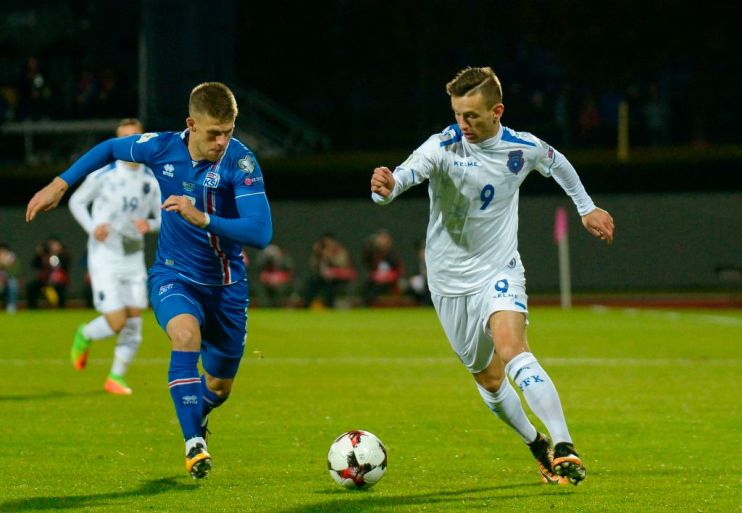 Iceland's forward Johann Berg Gudmundsson (L) and Kosovo's Bersant Celina vie for the ball during the FIFA World Cup 2018 qualification football match between Iceland and Kosovo in Reykjavik, Iceland on October 9, 2017. / AFP PHOTO / Haraldur Gudjonsson (Photo credit should read HARALDUR GUDJONSSON/AFP/Getty Images)