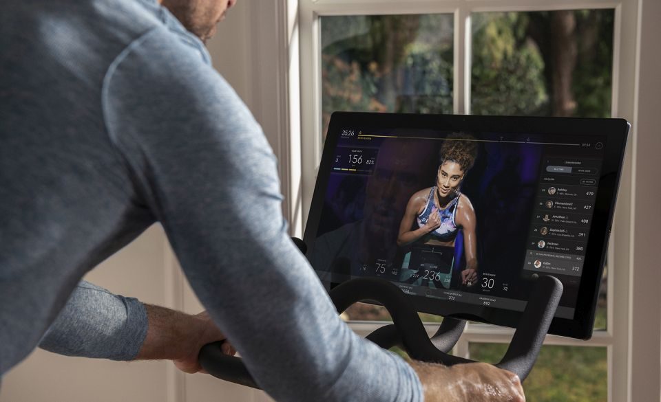 Peloton IPO: A man follows a live class on his Peloton bike screen