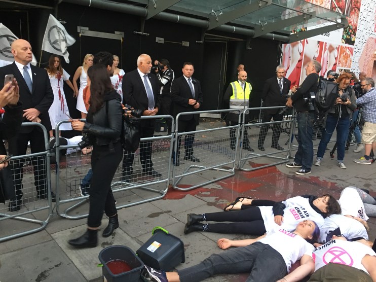 Extinction Rebellion protesters cover themselves in fake blood at London Fashion Week 'die-in'