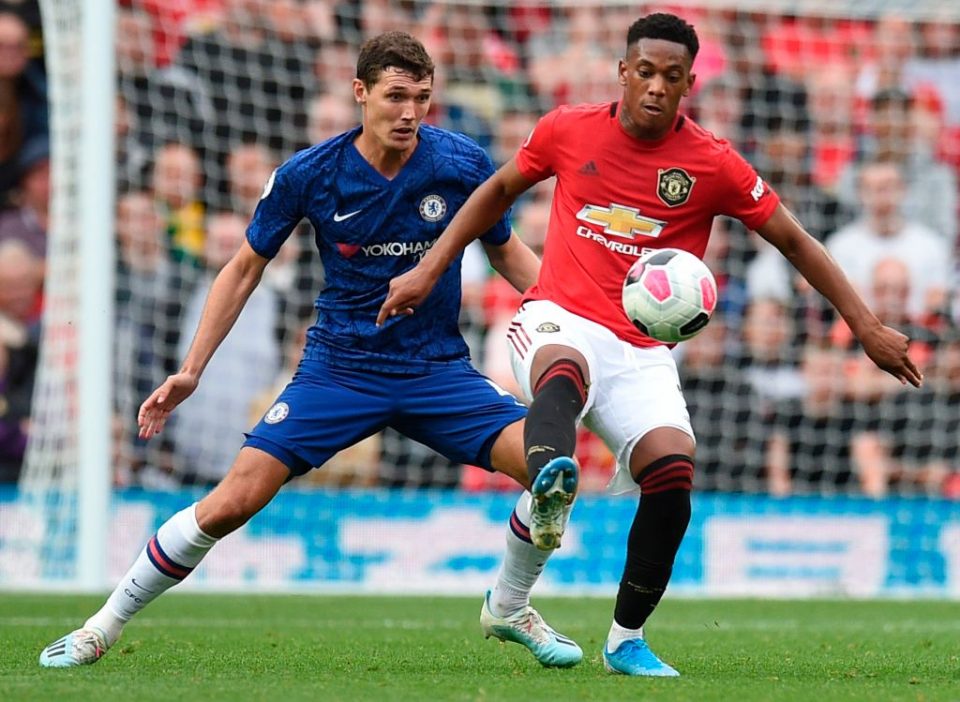 Chelsea's Danish defender Andreas Christensen (L) vies with Manchester United's French striker Anthony Martial (R) during the English Premier League football match between Manchester United and Chelsea at Old Trafford in Manchester, north west England, on August 11, 2019. - Manchester United won the game 4-0. (Photo by Oli SCARFF / AFP) / RESTRICTED TO EDITORIAL USE. No use with unauthorized audio, video, data, fixture lists, club/league logos or 'live' services. Online in-match use limited to 120 images. An additional 40 images may be used in extra time. No video emulation. Social media in-match use limited to 120 images. An additional 40 images may be used in extra time. No use in betting publications, games or single club/league/player publications. /         (Photo credit should read OLI SCARFF/AFP/Getty Images)