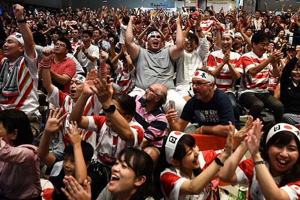 Japan fans celebrate at the "fanzone" area in Tokyo on October 13, 2019, during the Japan 2019 Rugby World Cup Pool A match between Japan and Scotland in Yokohama. (Photo by Anne-Christine POUJOULAT / AFP) (Photo by ANNE-CHRISTINE POUJOULAT/AFP via Getty Images)