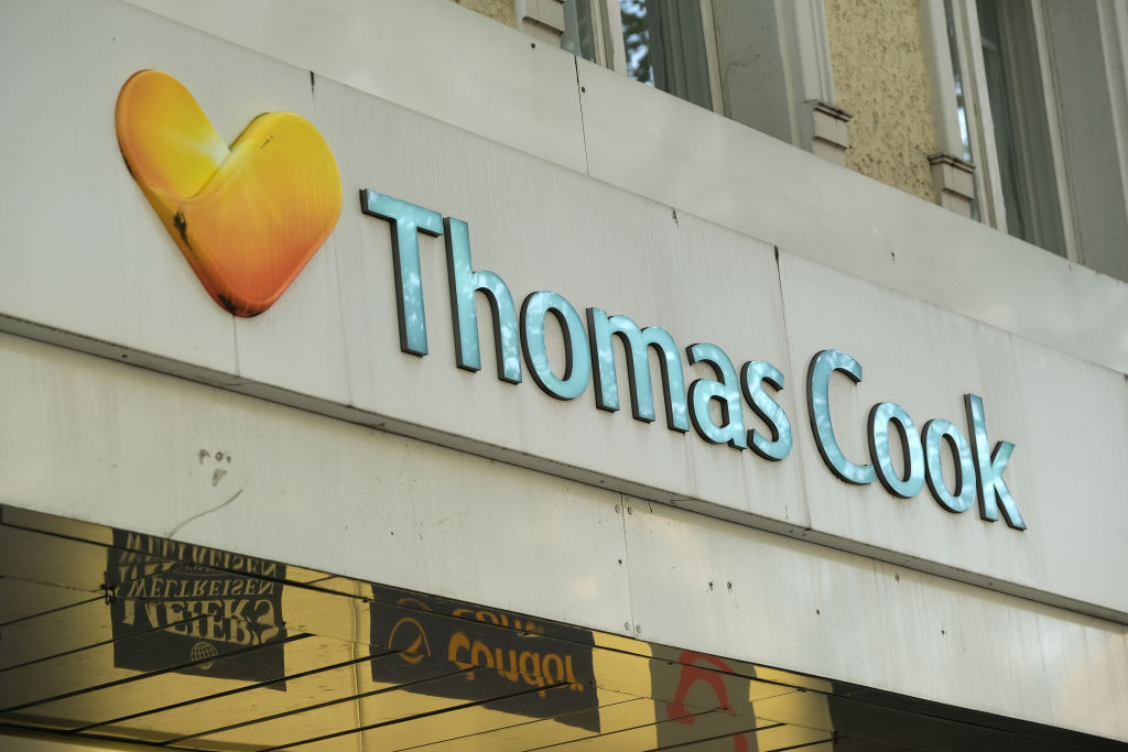 BERLIN, GERMANY - SEPTEMBER 23: The Thomas Cook logo hangs over a Thomas Cook travel agency store on September 23, 2019 in Berlin, Germany. Thomas Cook Group PLC in the United Kingdom announced today that it is filing for bankruptcy. In Germany the Thomas Cook subsidiary, Thomas Cook GmbH, has announced on its website that all vacations with departure dates for the 23rd and 24th of September will be cancelled and that it , along with Thomas Cook Touristik GmbH, Bucher Reisen & Öger Tours GmbH, might also have to file for bankruptcy. (Photo by Sean Gallup/Getty Images)