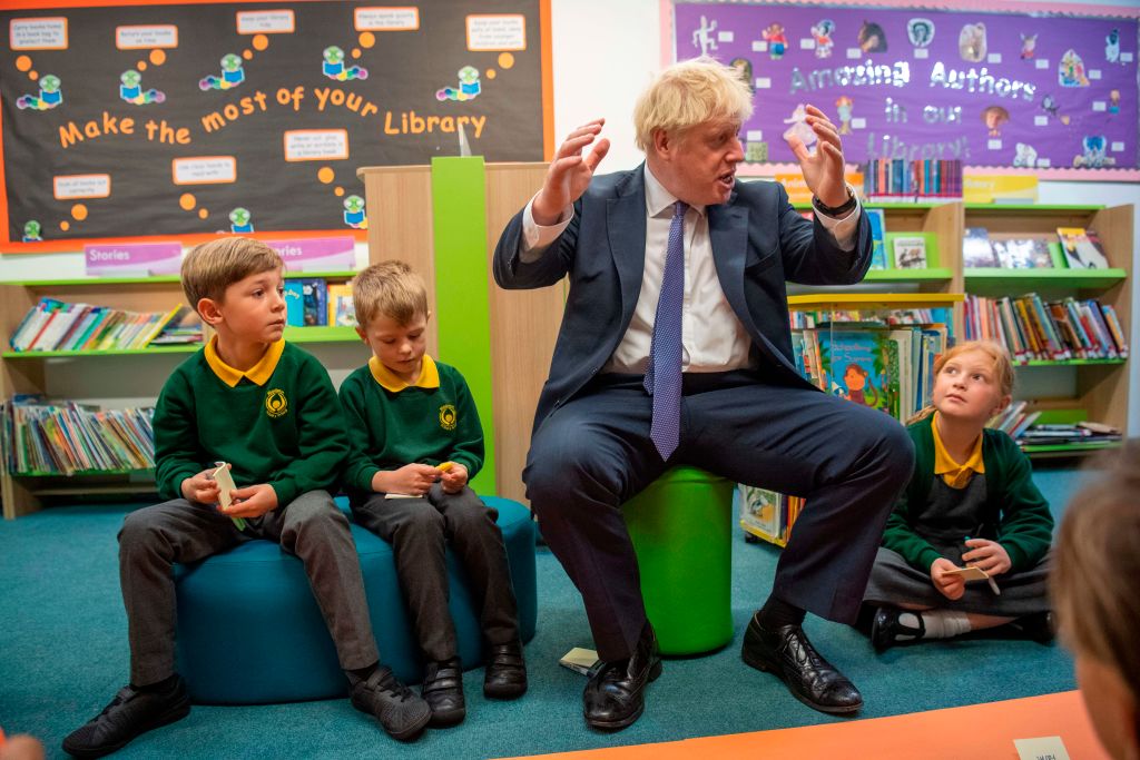 Britain's Prime Minister Boris Johnson speaks to pupils as he visits Middleton Primary School in Milton Keynes, southern England on October 25, 2019. - UK Prime Minister Boris Johnson on October 24 proposed settling the Brexit crisis through an early election on December 12 that could help Britain finally find a way out of the European Union. (Photo by Paul Grover / POOL / AFP) (Photo by PAUL GROVER/POOL/AFP via Getty Images)