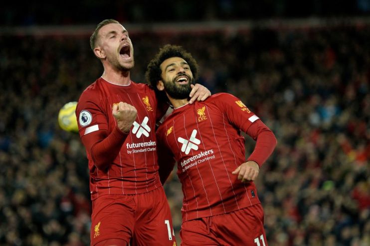 Liverpool's Egyptian midfielder Mohamed Salah (R) celebrates with Liverpool's English midfielder Jordan Henderson after scoring a penalty during the English Premier League football match between Liverpool and Tottenham Hotspur at Anfield in Liverpool, north west England on October 27, 2019. (Photo by STRINGER / AFP) / RESTRICTED TO EDITORIAL USE. No use with unauthorized audio, video, data, fixture lists, club/league logos or 'live' services. Online in-match use limited to 120 images. An additional 40 images may be used in extra time. No video emulation. Social media in-match use limited to 120 images. An additional 40 images may be used in extra time. No use in betting publications, games or single club/league/player publications. / (Photo by STRINGER/AFP via Getty Images)
