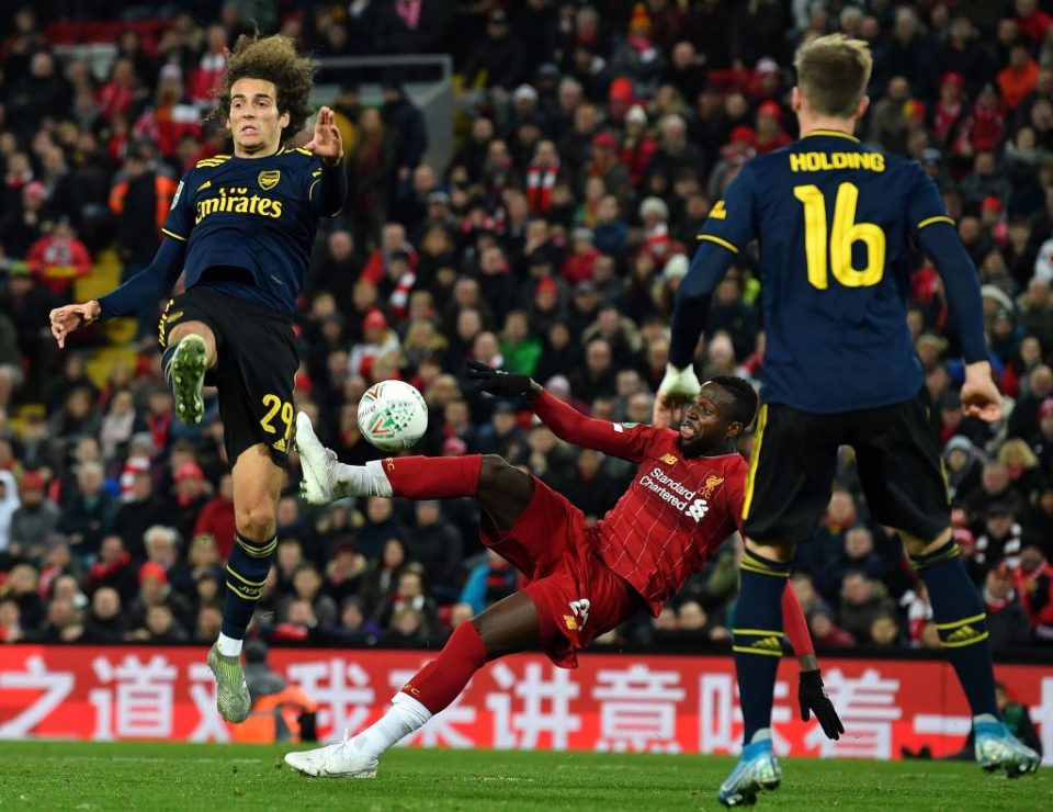 Liverpool's Belgium striker Divock Origi (C) scores his team's fifth goal during the English League Cup fourth round football match between Liverpool and Arsenal at Anfield in Liverpool, north west England on October 30, 2019. (Photo by Paul ELLIS / AFP) / RESTRICTED TO EDITORIAL USE. No use with unauthorized audio, video, data, fixture lists, club/league logos or 'live' services. Online in-match use limited to 75 images, no video emulation. No use in betting, games or single club/league/player publications. /  (Photo by PAUL ELLIS/AFP via Getty Images)