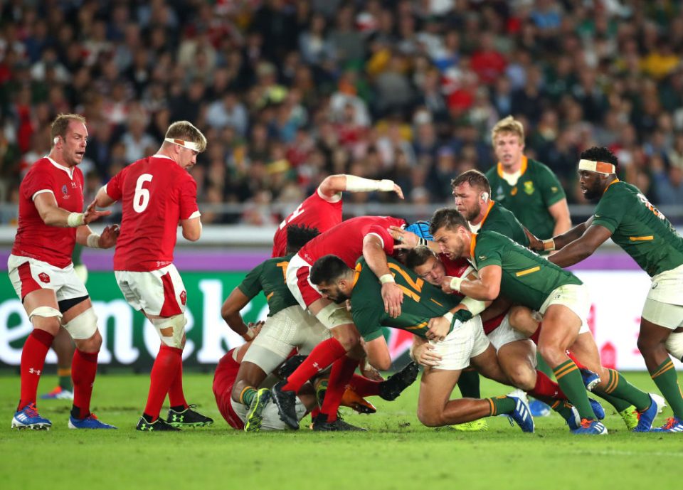 YOKOHAMA, JAPAN - OCTOBER 27: Hadleigh Parkes of Wales tackles Damian de Allende of South Africa during the Rugby World Cup 2019 Semi-Final match between Wales and South Africa at International Stadium Yokohama on October 27, 2019 in Yokohama, Kanagawa, Japan. (Photo by Cameron Spencer/Getty Images)