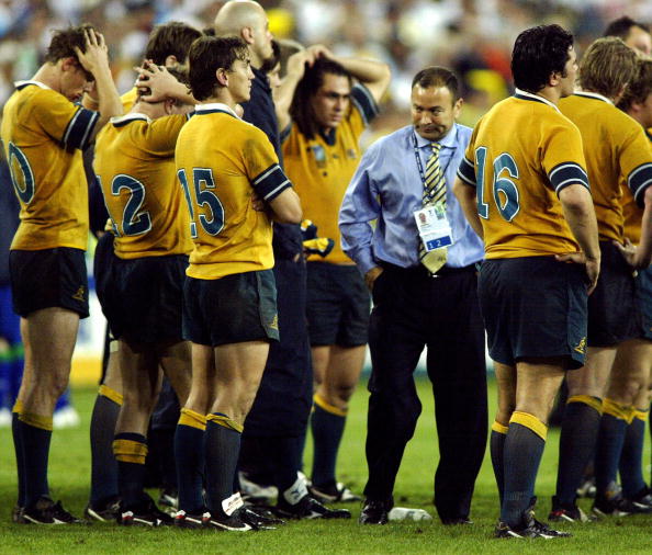 SYDNEY, Australia:  Australian coach Eddie Jones (3rdR) reacts with his players after losing the Rugby World Cup final between Australia and England at the Olympic Park Stadium in Sydney, 22 November 2003. England beat Australia 20-17.     AFP PHOTO/Peter PARKS  (Photo credit should read PETER PARKS/AFP via Getty Images)