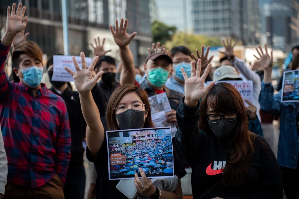 People gather in support of pro-democracy protesters during a lunch break rally in the Kwun Tong area in Hong Kong