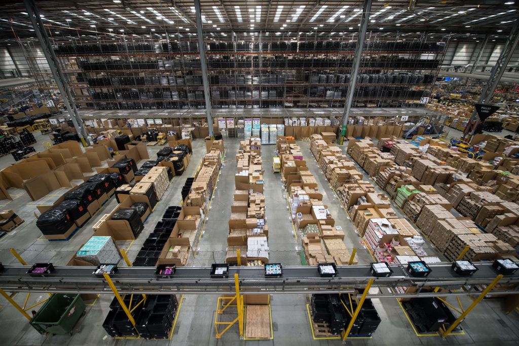 Workers prepare customer orders for Black Friday in an Amazon fulfillment centre in Peterborough