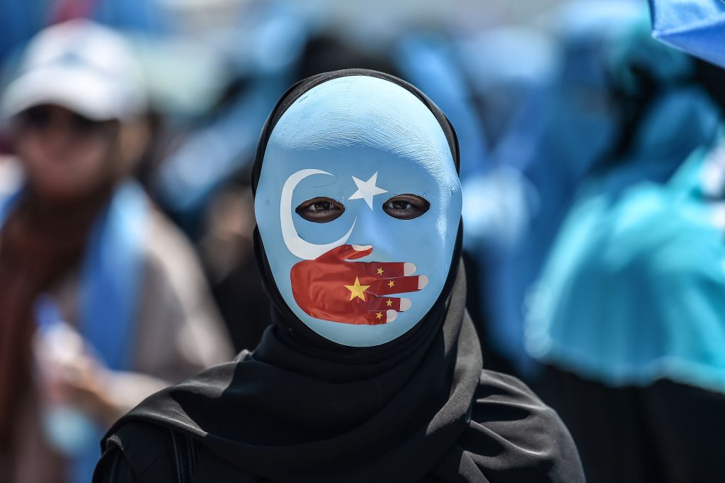 A demonstrator protests China's treatment of ethnic Uighur Muslims 