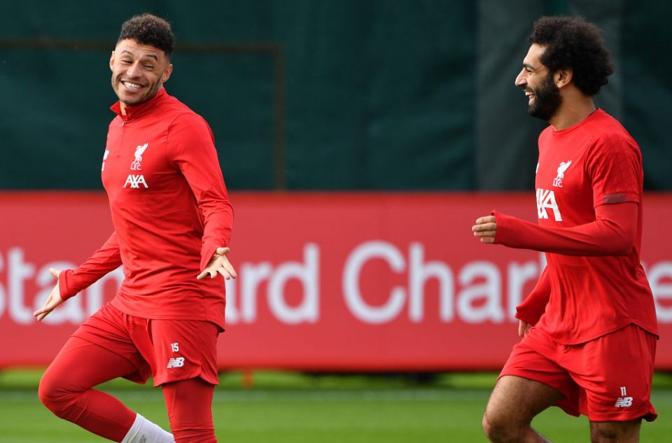 Liverpool's English midfielder Alex Oxlade-Chamberlain (L) and Liverpool's Egyptian midfielder Mohamed Salah react during a team training session at Melwood in Liverpool, north west England on October 22, 2019, on the eve of their UEFA Champions League Group E football match against Genk. (Photo by Paul ELLIS / AFP) (Photo by PAUL ELLIS/AFP via Getty Images)