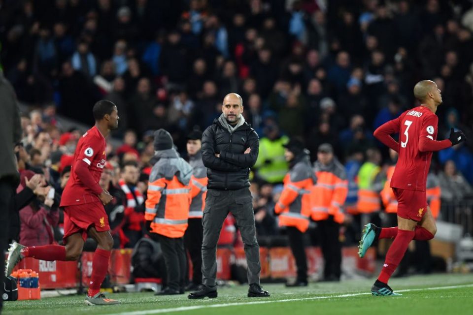 Manchester City's Spanish manager Pep Guardiola (C) watches the Liverpool team run out at the start of the second half during the English Premier League football match between Liverpool and Manchester City at Anfield in Liverpool, north west England on November 10, 2019. (Photo by Paul ELLIS / AFP) / RESTRICTED TO EDITORIAL USE. No use with unauthorized audio, video, data, fixture lists, club/league logos or 'live' services. Online in-match use limited to 120 images. An additional 40 images may be used in extra time. No video emulation. Social media in-match use limited to 120 images. An additional 40 images may be used in extra time. No use in betting publications, games or single club/league/player publications. /  (Photo by PAUL ELLIS/AFP via Getty Images)